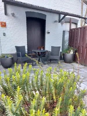 two chairs and a table on a patio at Le BELLEA in Verviers