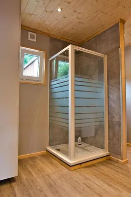 a room with a large glass door in a house at Le gîte de l'écurie des Saules in Plombières