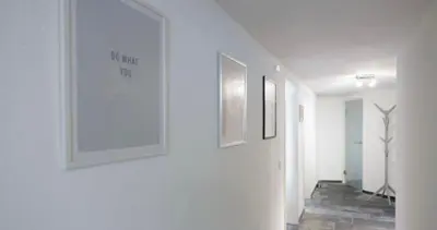 a hallway with three framed pictures on the wall at Grey House in Olne
