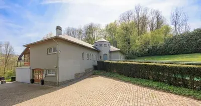 a large white house with a brick driveway at Grey House in Olne