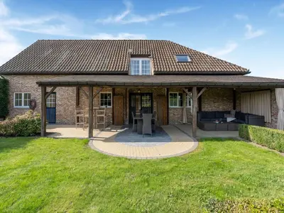 a brick house with a pavilion in a yard at Alken Farm Stay with Terrace in Alken