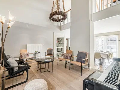 a living room with chairs and a table at Alken Farm Stay with Terrace in Alken