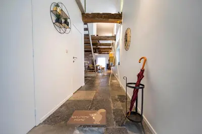 a long hallway with an umbrella on the floor at L'atelier de Liège: Tranquillité & Effervescence in Liège