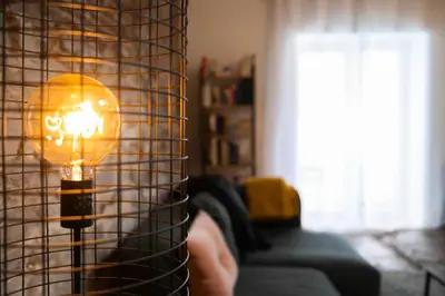 a lamp in a living room with a couch at L'atelier de Liège: Tranquillité & Effervescence in Liège