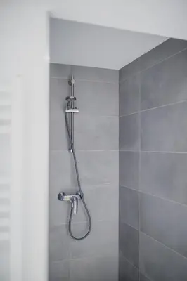 a shower with a shower head in a bathroom at Le Mayou in Mortroux