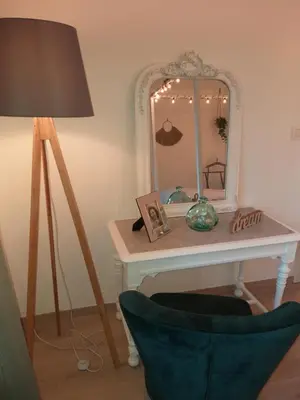 a dressing table with a mirror and a lamp at La Maison de Sidonie in Jalhay