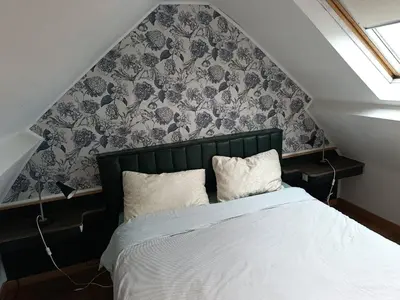 a bedroom with a bed with a black and white wallpaper at liège 4420 rue jean Jaurès 45 grande maison joyeuse avec terrasse 30m2 pour 8 personnes maximum in Saint-Nicolas