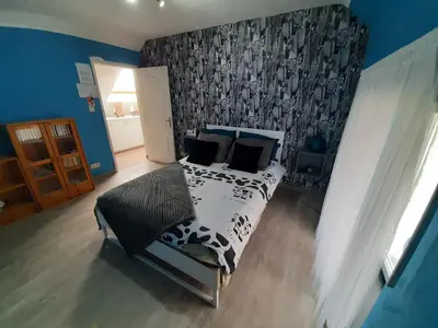 a bedroom with a bed with a black and white blanket at Superb vacancy at Patricks house in Ketzingen
