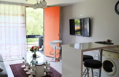 a living room with a table and a window at Calme et verdure 9 in La Calamine