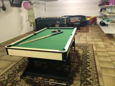 a pool table with two cuesticks on top of it at 14P 5B Villa de Poothoeve with Sauna and beautiful garden in Bilzen