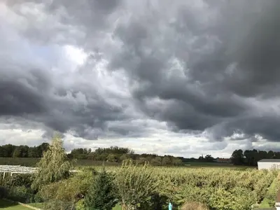 a cloudy sky over a field of crops at 8P 3B Cozy vacation home for 8 persons in Heers in Heers