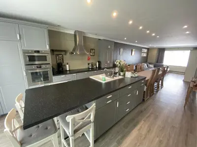 a kitchen with a large island with a counter top at 8P 3B Cosy vacation home for 8 persons in Heers