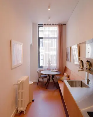 a small kitchen with a table and a window at La Maison de Chestret in Liège