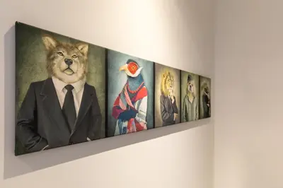 a painting of a cat in a suit hanging on a wall at GUILLEMINS STATION FLATS in Liège