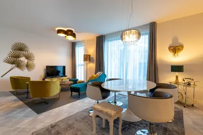 a living room with a table and chairs at GUILLEMINS STATION FLATS in Liège