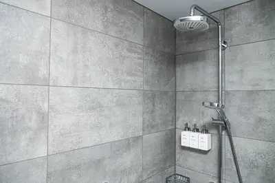 a bathroom with a shower with a shower head at Radisson Hotel Liege City Centre in Liège