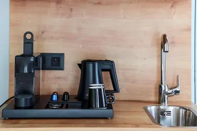 a coffee maker sitting on a counter next to a sink at Radisson Hotel Liege City Centre in Liège