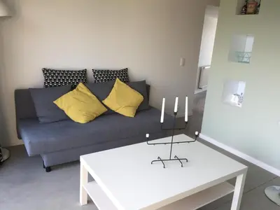 a living room with a couch and a table at Le temps d’une balade. in Olne
