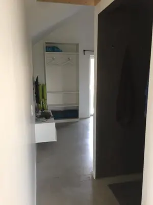 a room with a hallway with a black door at Le temps d’une balade. in Olne