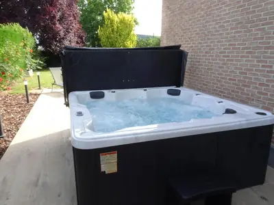 a jacuzzi tub in a brick building at Heers Retreat with Sauna in Heers