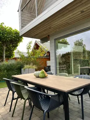 a wooden table with pumpkins sitting on a patio at Ons Maashuisje in Maaseik