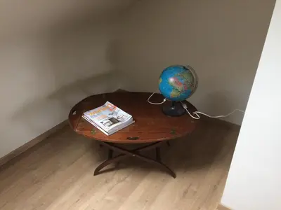 a table with a globe and a book on it at Gezellig stadshuisje met patio. in Tongeren