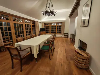 a dining room with a table and chairs and a chandelier at Hoeve Luitenant Halleux in Linter