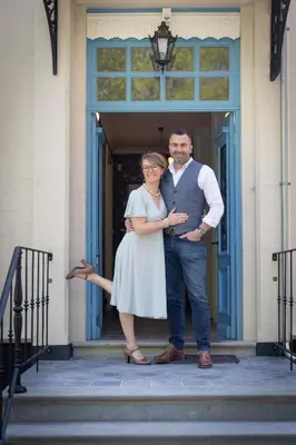 a man and a woman standing on the steps at Villa les Bruyères in Dilsen-Stokkem