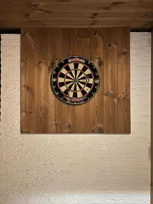 a dart board on the wall of a building at Vakantiewoning De Winning in Houthalen-Helchteren