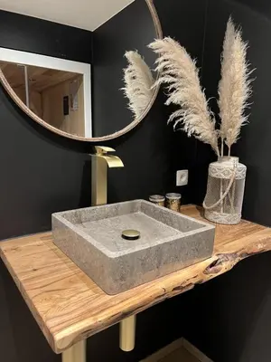 a bathroom with a concrete sink and a mirror at Vakantiewoning De Winning in Houthalen-Helchteren
