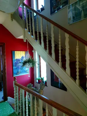 a staircase in a home with red walls and a stair case at L'Atelier Bed and Breakfast in Andrimont