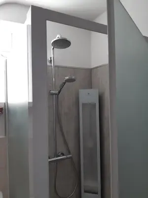 a shower with a shower head in a bathroom at Aan het Singelhof - Mirabelle -- 4 sterren -- met sunshower en tuin in Sint-Truiden