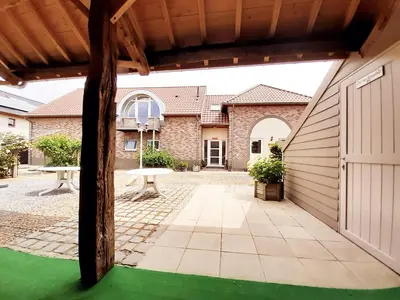 a view of a garage with a green floor at Aan het Singelhof - Mirabelle -- 4 sterren -- met sunshower en tuin in Sint-Truiden
