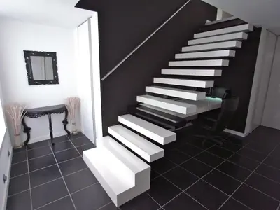 a staircase in a room with black walls and tile floors at B&B Bianero in Peer
