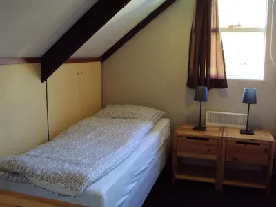 a bedroom with a bed and a dresser and a window at Vakantiewoning P3F in Plombières
