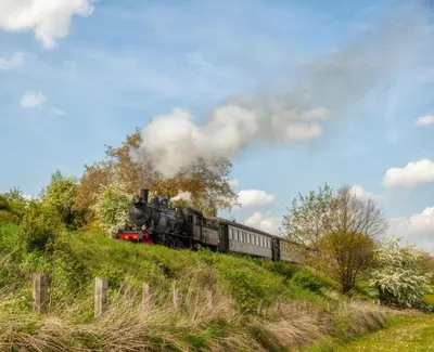 a steam train is coming down a hill at Vakantiewoning P3F in Plombières