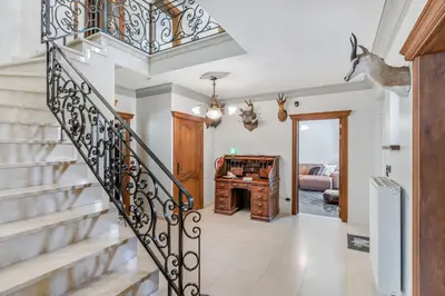 a staircase in a house with a piano at Huize Koedoe in Tongeren