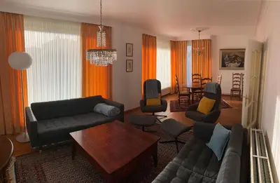 a living room with a couch and a table at De Lelie in Achel