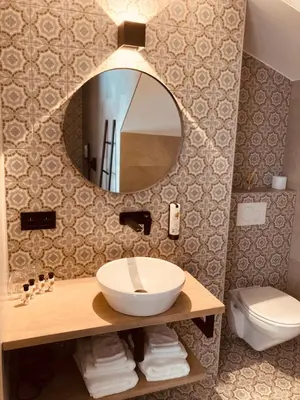 a bathroom with a sink and a mirror at De Molenhoeve B&B in Voeren