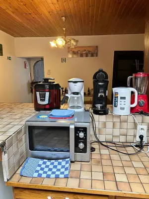 a microwave sitting on a counter in a kitchen at Bien-être-Au-calme et parking gratuit in Seraing
