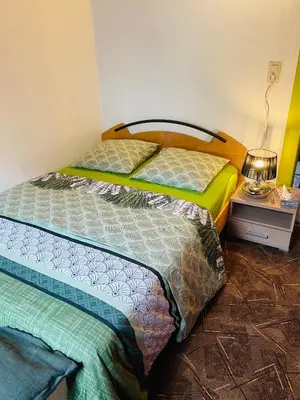 two beds sitting next to each other in a room at Bien-être-Au-calme et parking gratuit in Seraing