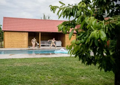 two people standing in the swimming pool of a house at B&B De Fruithoeve in Hoeselt