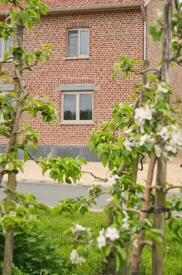 a brick building with a window on the side of it at B&B De Fruithoeve in Hoeselt