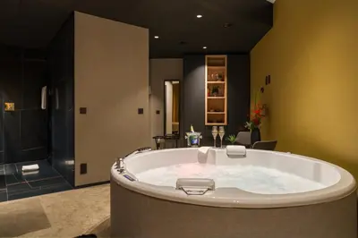 a large bathroom with a large tub in a room at Aux Etangs - Hôtel in Battice