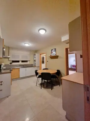 a kitchen with a table and chairs in a room at Susberg 3 in Pelt