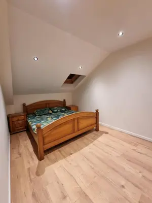 a bedroom with a wooden bed in a attic at Susberg 4 in Pelt