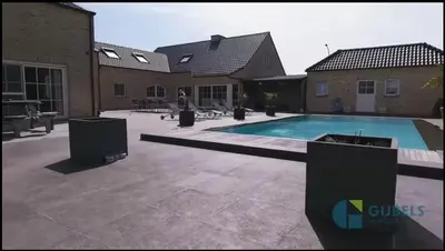 a swimming pool in front of a building at Susberg 4 in Pelt