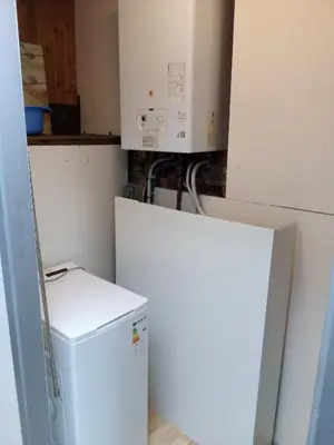 a small kitchen with a white refrigerator and a microwave at Agréable maison avec cour à 10min de Liège in Herstal