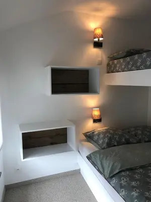 a room with two beds and a tv on the wall at Gîte Jaja in Limbourg