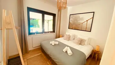 a bedroom with a bed with towels on it at La douce Rive in Esneux